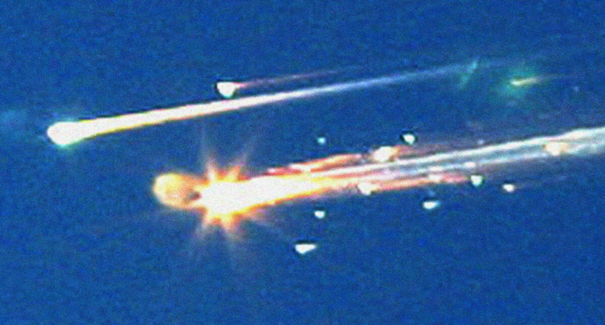 In this Feb. 1, 2003 file photo, debris from the space shuttle Columbia streaks across the sky over Tyler, Texas. (AP Photo/Dr. Scott Lieberman, File)