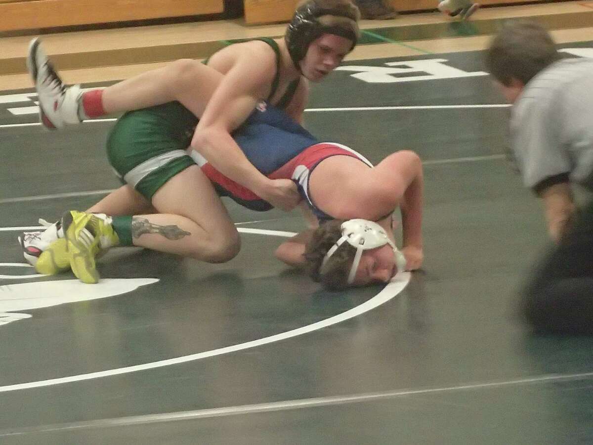 New Milford's Tyler Schultz, top, pinned New Fairfield's Braden Reilly to win the 126-pound match and help lead the Green Wave to a 41-28 victory in their dual meet on Jan. 27, 2016.