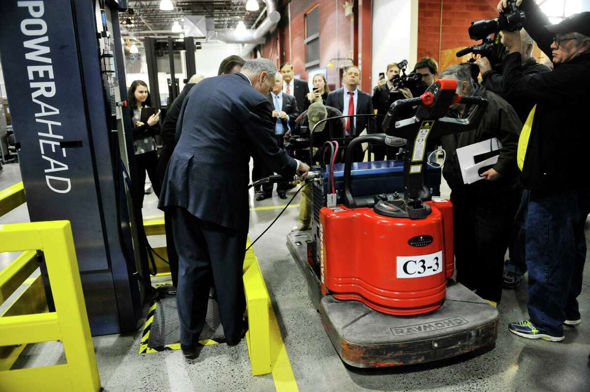Senator Charles E. Schumer helps to perform the 1 millionth refueling of a GenDrive fuel cell from a GenFuel dispenser at Plug Power during a tour of the company on Monday, Feb. 1, 2016, in Latham, N.Y. (Paul Buckowski / Times Union)