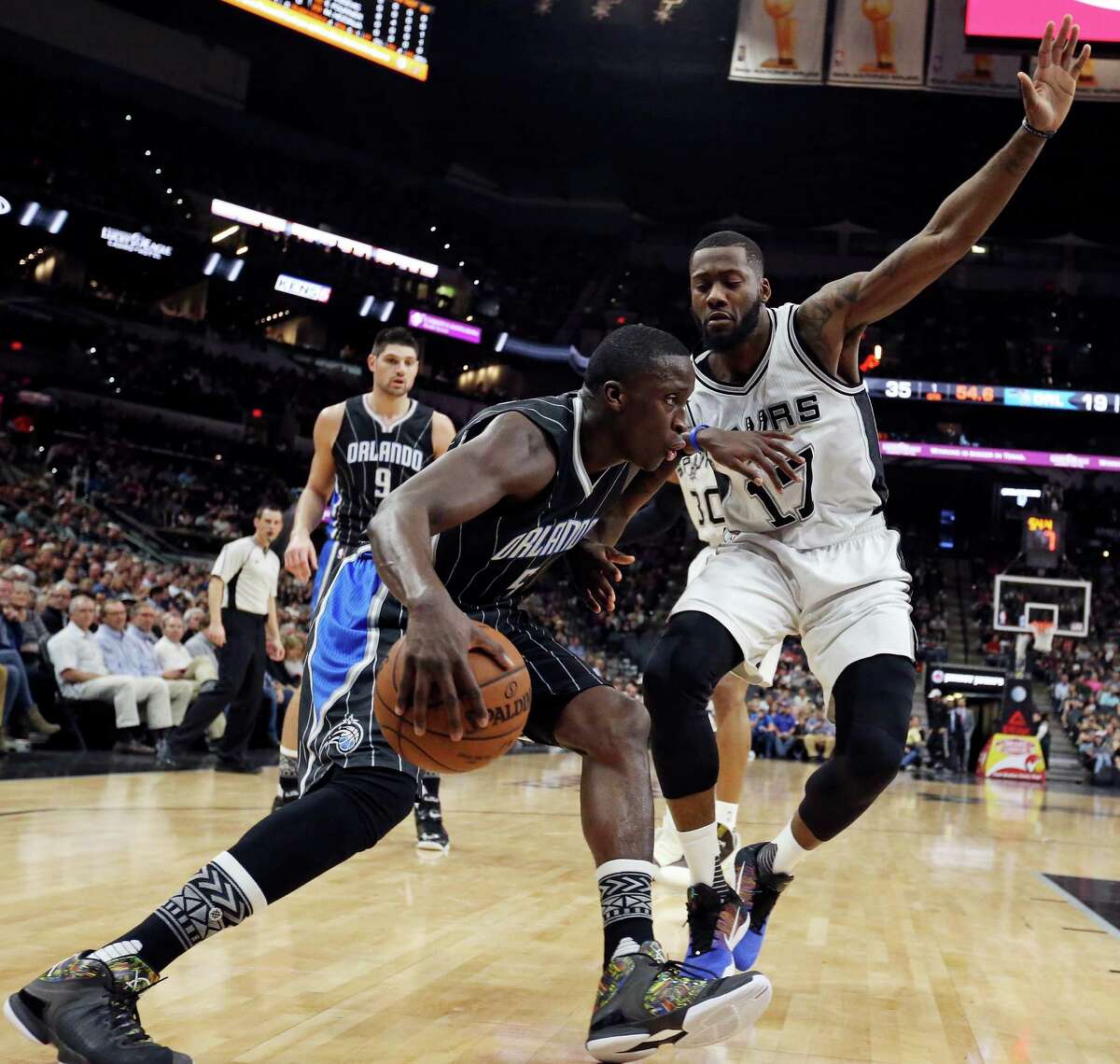 San Antonio Spurs' Jonathon Simmons defends Orlando Magic's Victor Oladipo during first half action Monday Feb. 1, 2016 at the AT&T Center.