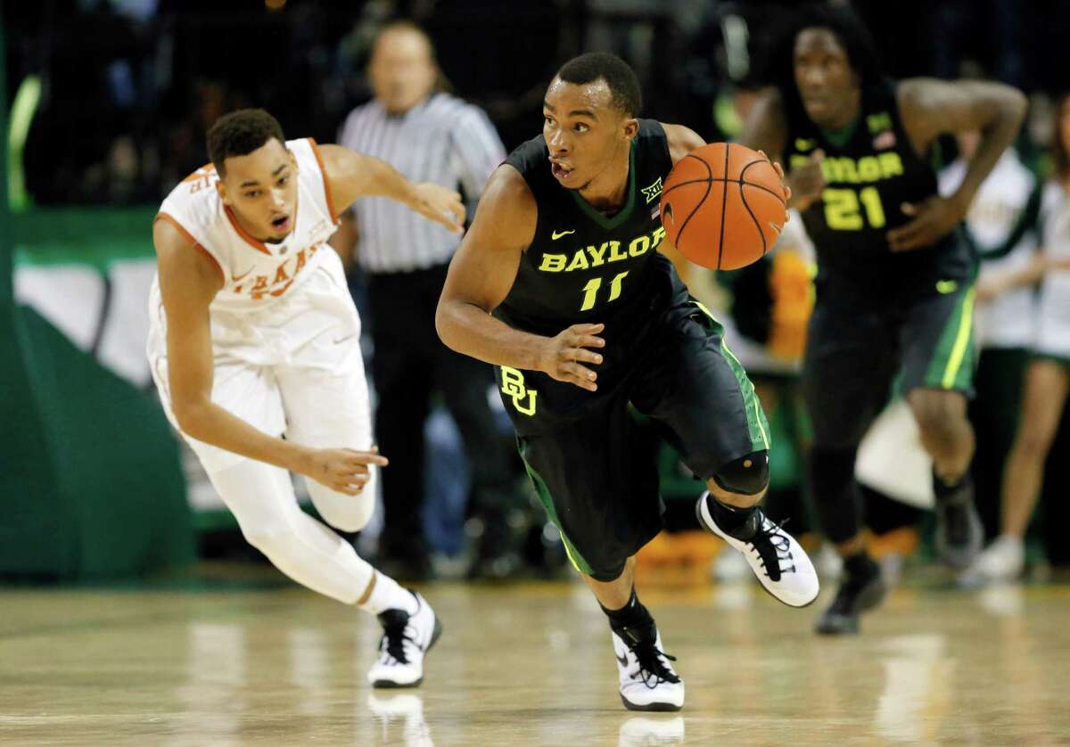 Baylor's Lester Medford (11) comes away with a steal against Texas's Eric Davis Jr., rear, in the second half of an NCAA college basketball game, Monday, Feb. 1, 2016, in Waco, Texas. Texas won 67-59. (AP Photo/Tony Gutierrez)