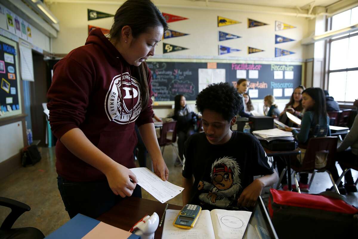 Teacher Yuka Walton helps a student with his math homework in advisory class at James Denman Middle School in San Francisco, California, on Tuesday, Feb. 2, 2016.