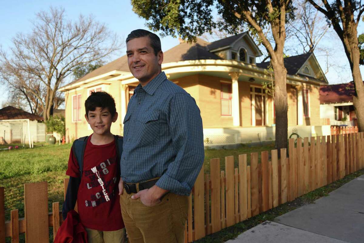 Former legislator and ex-mayoral candidate Mike Villarreal with his son Marcos in front of their historic home located in the historic King William District. Villarreal hopes to install 45 solar panels on his roof and a rear accessory structure at his home.