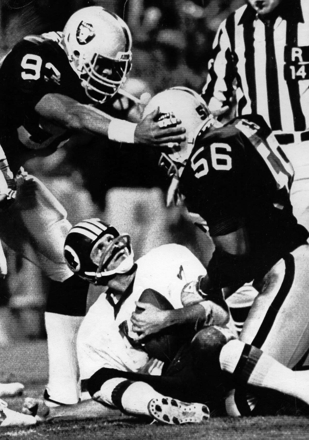 Los Angeles Raiders vs Washington Redskins in Super Bowl XVIII .. Jeff Barnes sacks quarterback Joe Theisman. Greg Townsend congratulates Barnes. UPI photo Photo ran1/23/1984, P. 44