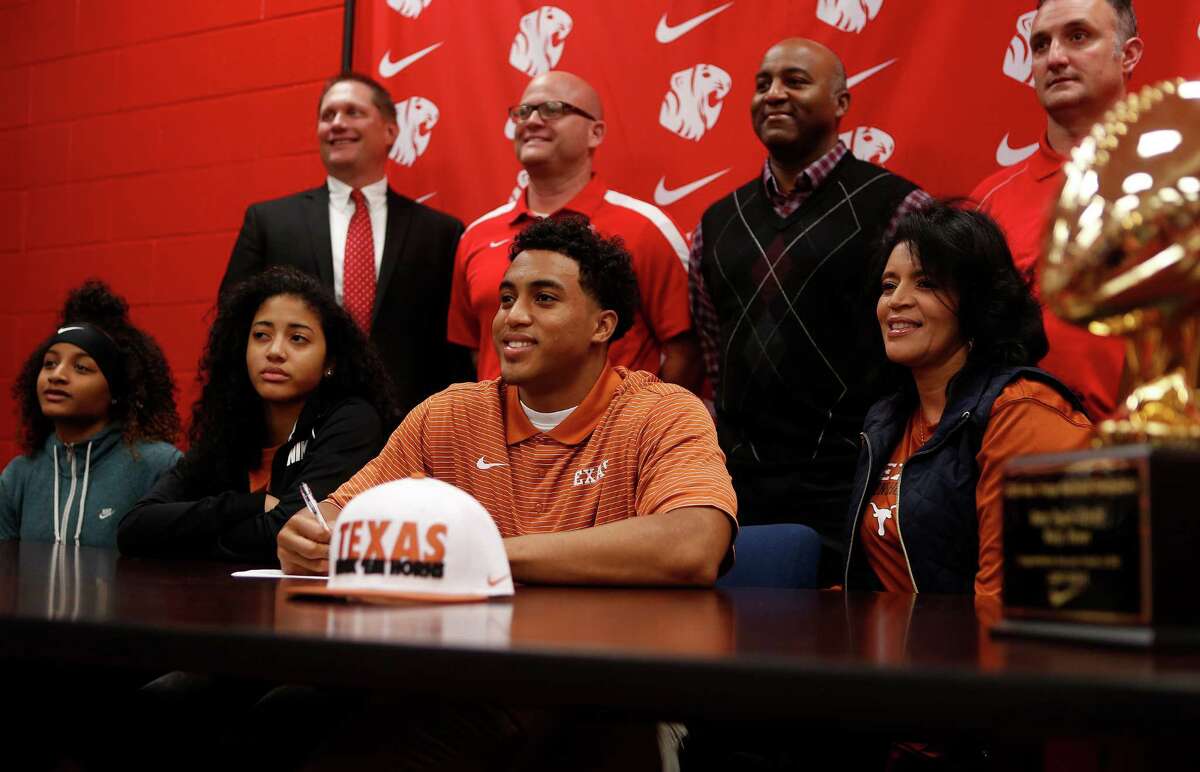 Kyle Porter is surrounded by family as he has his photo taken during signing day festivities inside the field house at Katy High School, Wednesday, Feb. 3, 2016, in Houston.