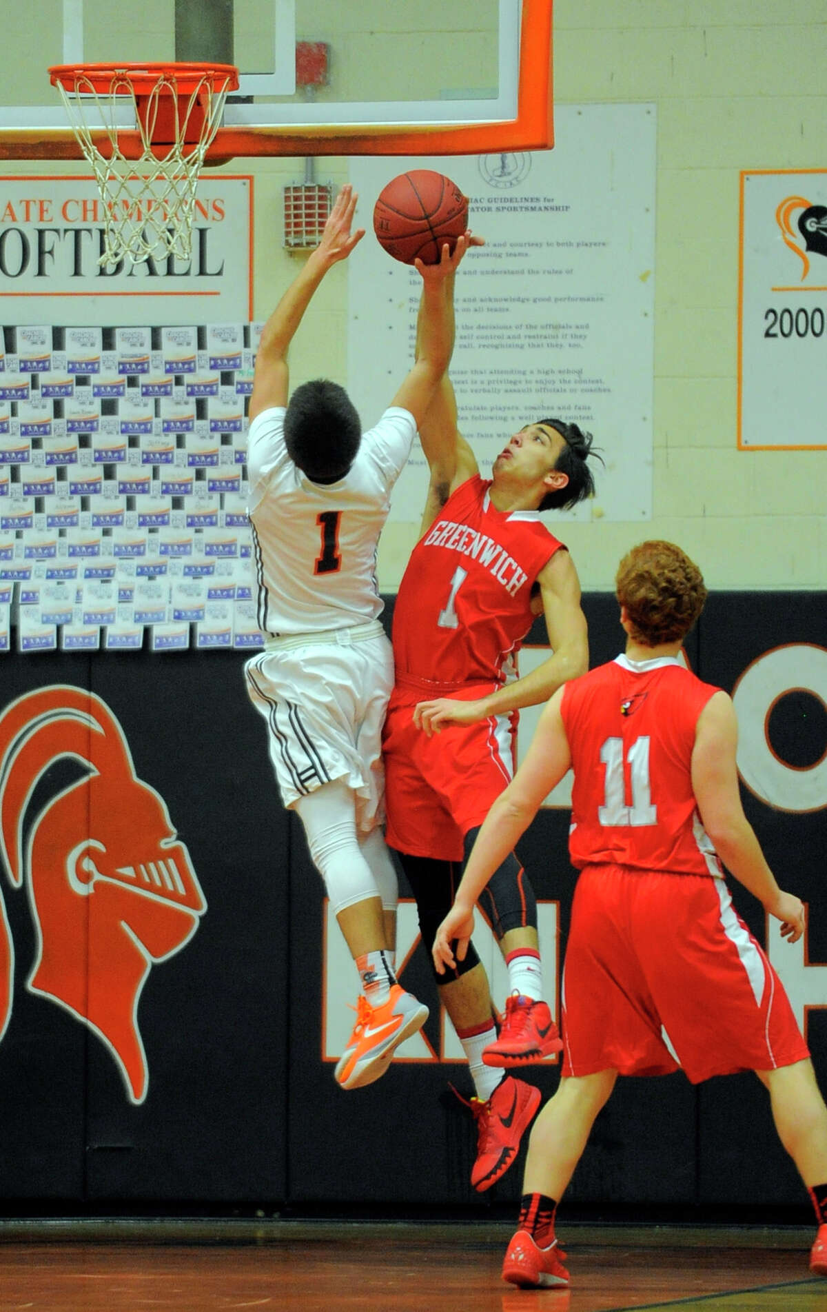 Greenwich's Michael Gianopoulos blocks the shot of Stamford's Nico Laveris in the first half Wednesday in Stamford.