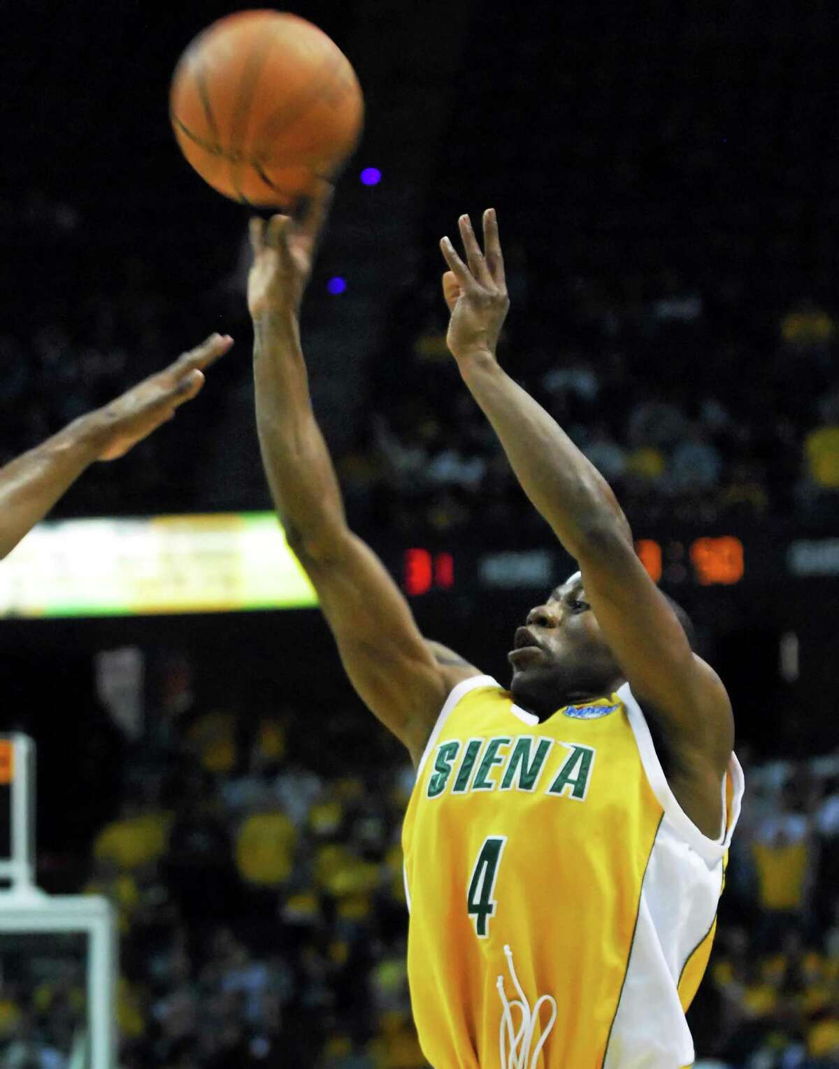 Times Union staff photo by John Carl D'Annibale: Siena's #4, Tay Fisher sinks a three pointer during first half play in the MAAC tournament final from the Times Union Center in Albany Monday night March 10, 2008. FOR GAME STORY