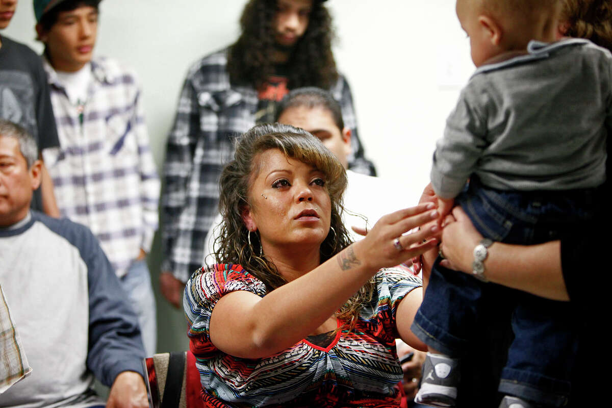 metro - Sabrina Benitez reaches for her son, Jeidan Davis, who will be one-year-old on Feb. 18, during a event with a prayer and balloon release for her son, Joshua Davis Jr., on the one-year anniversary of his disappearance in New Braunfels, at the Heidi Search Center in San Antonio on Saturday, Feb. 4, 2012. Lisa Krantz/San Antonio Express-News