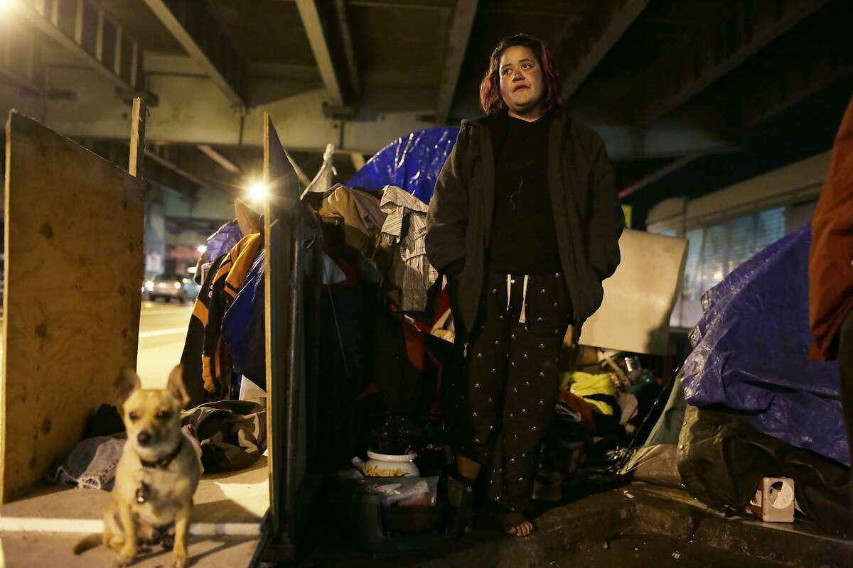 Debra Lujan stands outside her tent on 13th Street in the evening of Tuesday, January 12, 2016 in San Francisco, Calif.