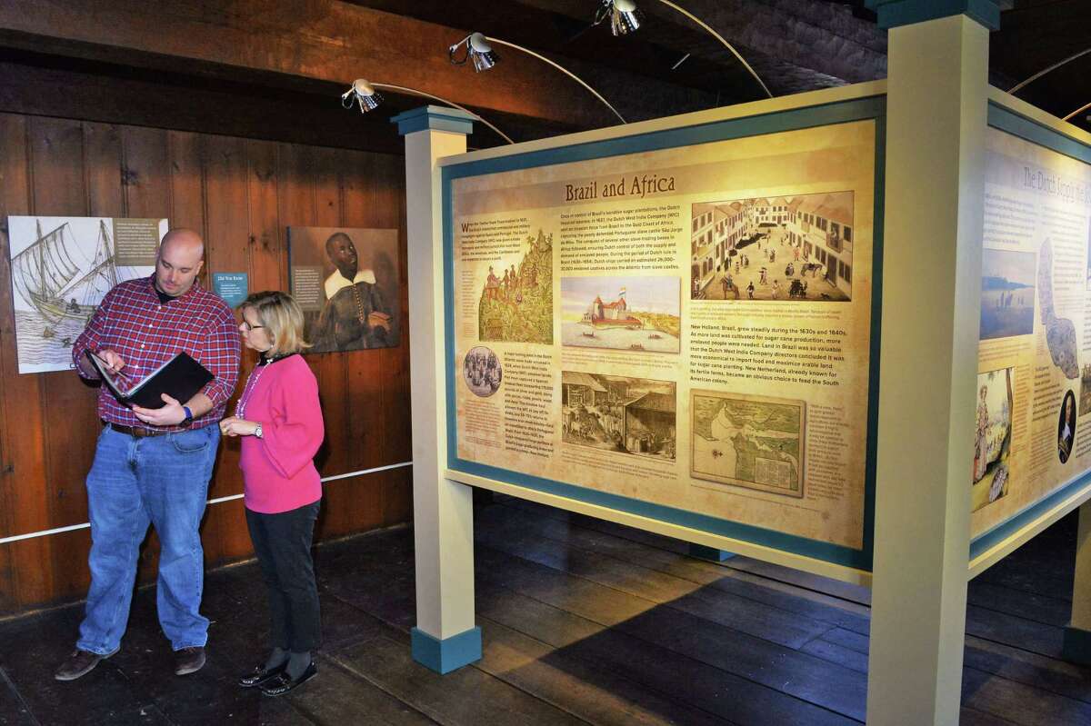 Historic site assistant Geoff Benton, left, and site manager Heidi Hill ready the new exhibit "A Dishonorable Trade: Human Trafficking in the Dutch Atlantic World," about the Van Rensselaer family's slaves at the Fort Crailo state historic site Thursday Jan. 28, 2016 in Rensselaer, NY. (John Carl D'Annibale / Times Union)