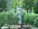 An angel statue watches over the backyard of Amy Backlas in Lake Jackson. Her yard is is wildlife certified and draws lots of birds, bees, butterflies and other pollinators.