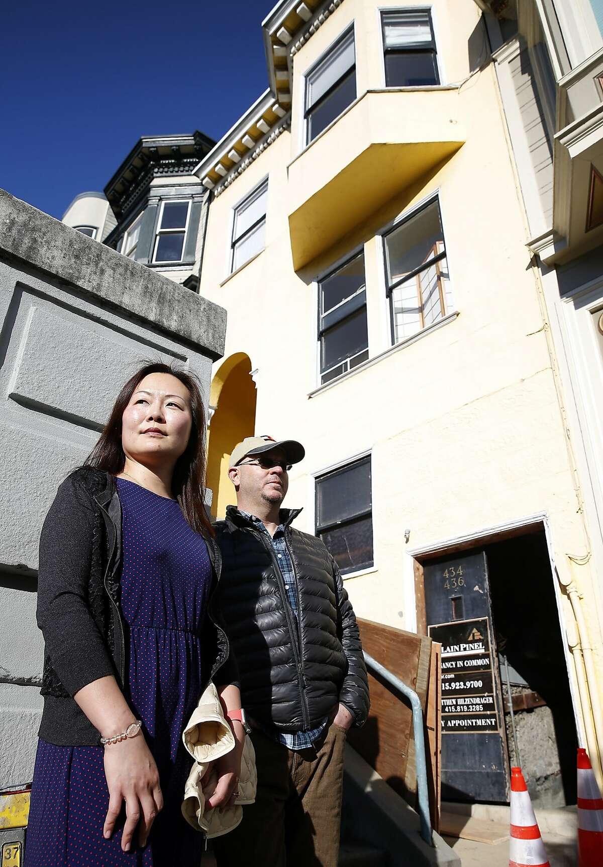 Michelle Huang and Tom Payne stop in front of the building on Vallejo Street where they own three TIC units in San Francisco, Calif. on Thursday, Feb. 4, 2016. They are embroiled in a feud with the owner of one of the other units who rented one of theirs through Airbnb and is now claiming residency asserting tenants rights.