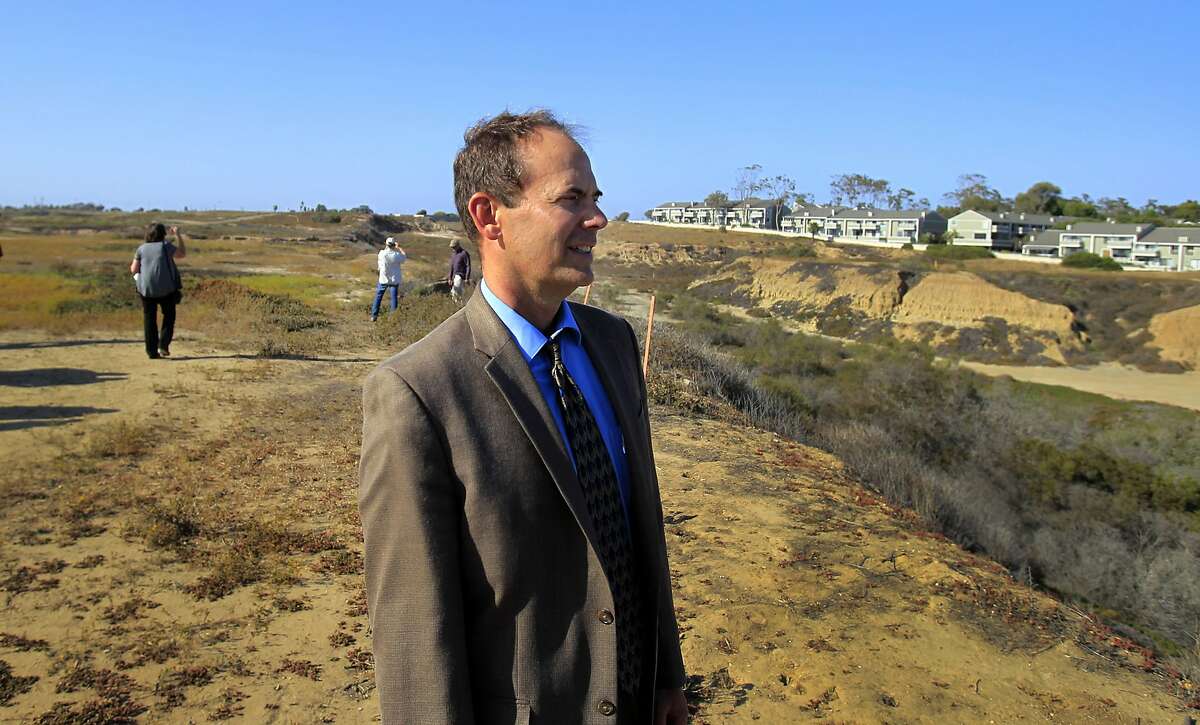 Coastal Commission Executive Director Charles Lester takes a tour at a proposed development project in Newport Beach, Calif., in a June 2014 file image. Members of the California Coastal Commission are moving to fire Lester, with a meeting scheduled for Feb. 10, 2016, the next step.