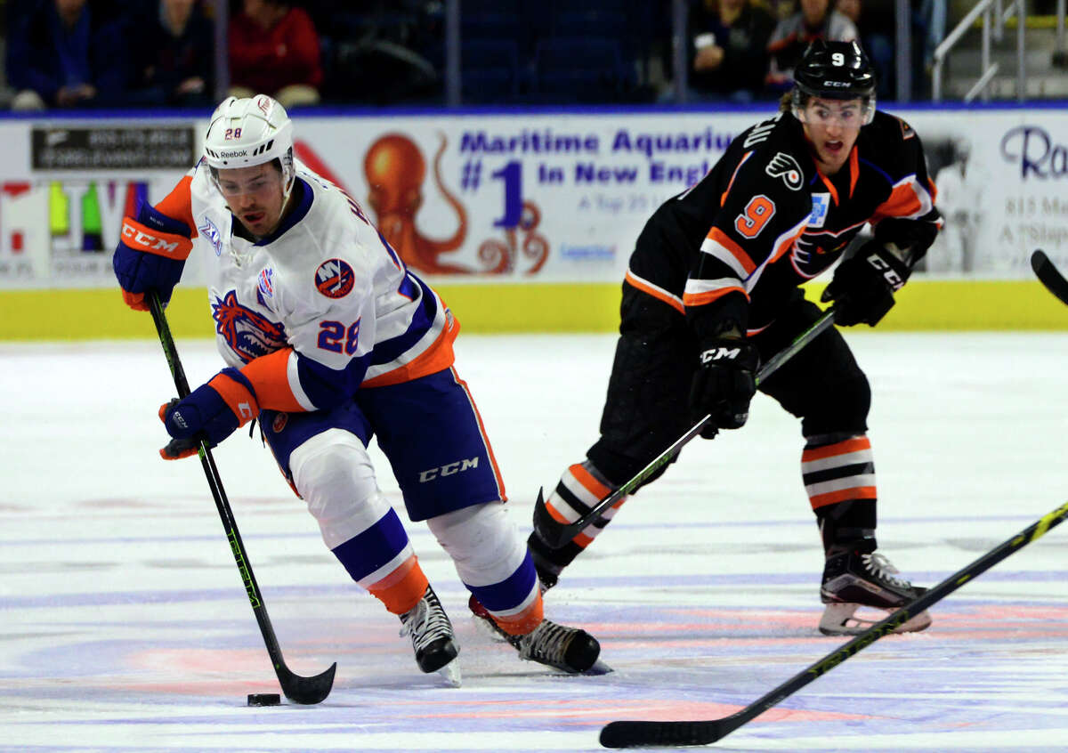 Sound Tigers' Mike Halmo moves the puck as Lehigh Valley's Cole Bardreau tracks him during AHL hockey action at the Webster Bank Arena in Bridgeport, Conn. on Friday Feb. 5, 2016.