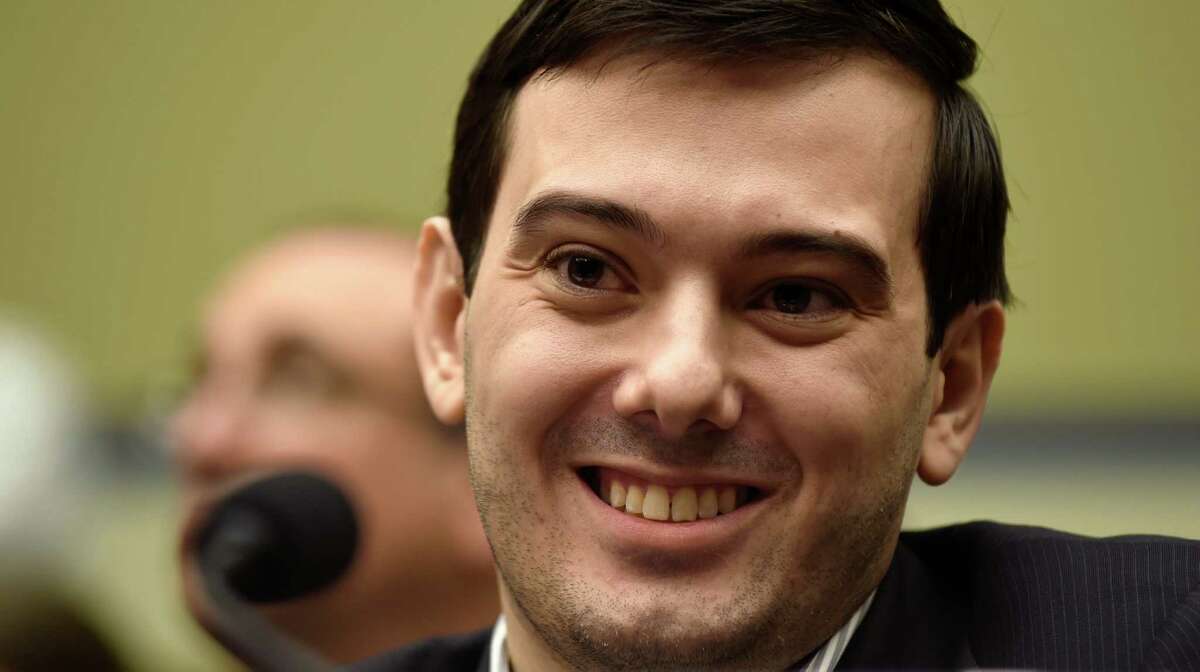 FILE - In this Feb. 4, 2016 file photo, Pharmaceutical chief Martin Shkreli smiles on Capitol Hill in Washington during the House Committee on Oversight and Reform Committee hearing on his former company's decision to raise the price of a lifesaving medicine. Shkreli briefly united Democrats and Republicans on Capitol Hill this week, as lawmakers took turns blasting the price-hiking former CEO who has become the new poster child for corporate greed. (AP Photo/Susan Walsh)