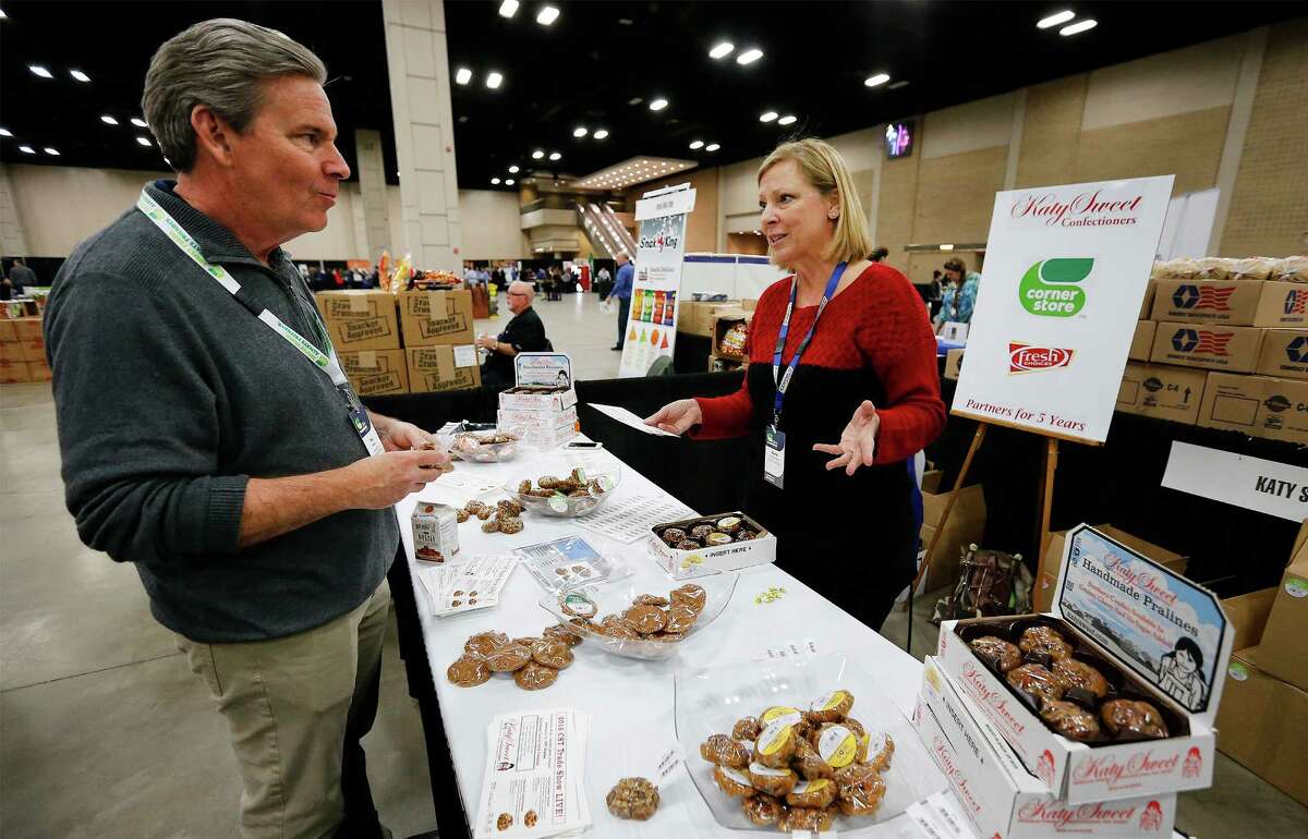 President of Operations at CST Brands Hal Adams (left) chats with Katy Sweet Confectioners' Gina Minzenmeyer as CST Brands holds in its annual convention for store managers at the Convention Center in San Antonio on Thursday, Feb. 4, 2016. Managers from 1,200 company-owned stores get to visit with about 100 suppliers to see a cross section of new products offered to CST to enhance sales in their stores. Katy Sweet has been doing business with CST Brands for five years according to Minzenmeyer. (Kin Man Hui/San Antonio Express-News)