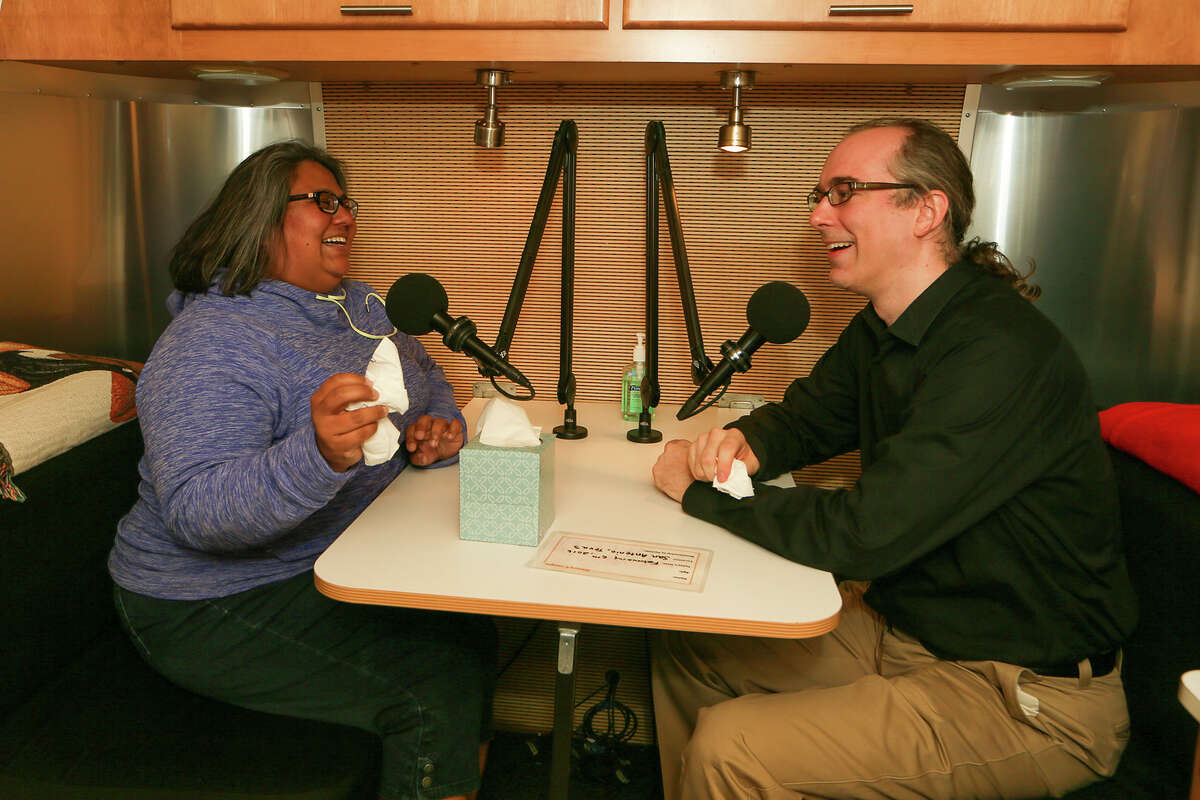 Texas Public Radio’s Elisa Gonzales and Nathan Cone sit in the recording studio of the Story- Corps mobile trailer at Central Library. TPR is hosting StoryCorps here through March 5.