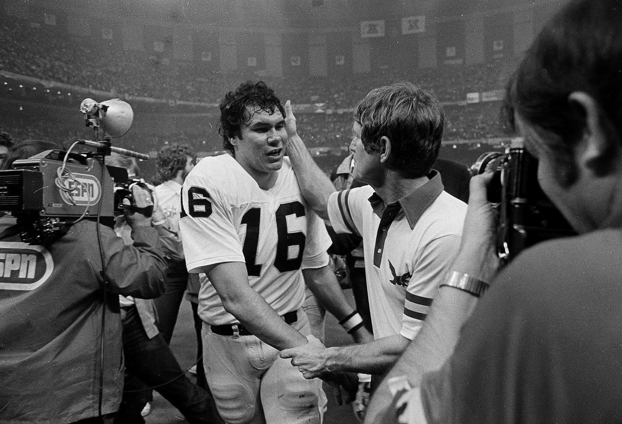 Oakland Raiders quarterback Jim Plunkett takes a snap during the