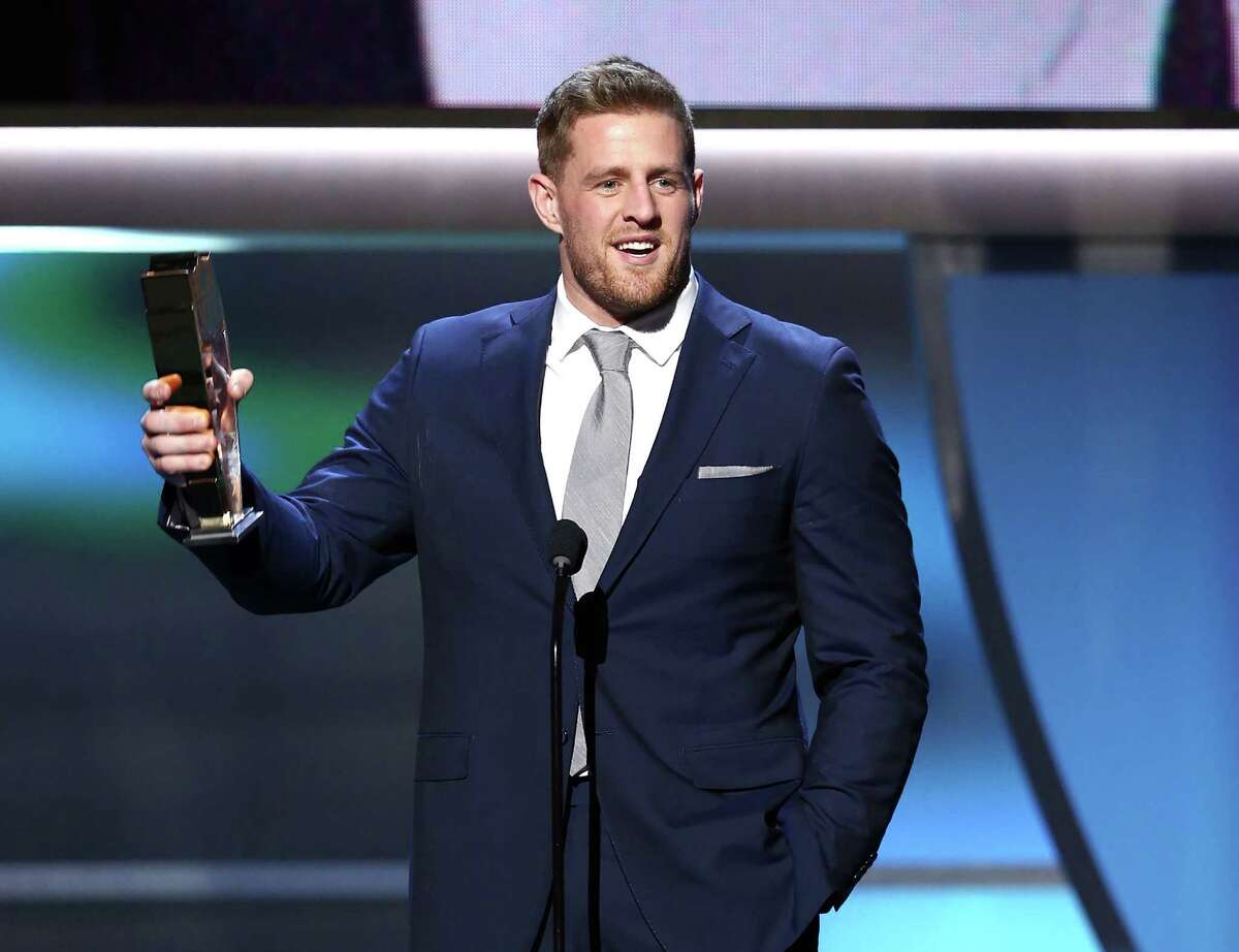 The Texans' J.J. Watt accepts the NFL Defensive Player of the Year trophy Saturday in San Francisco.﻿