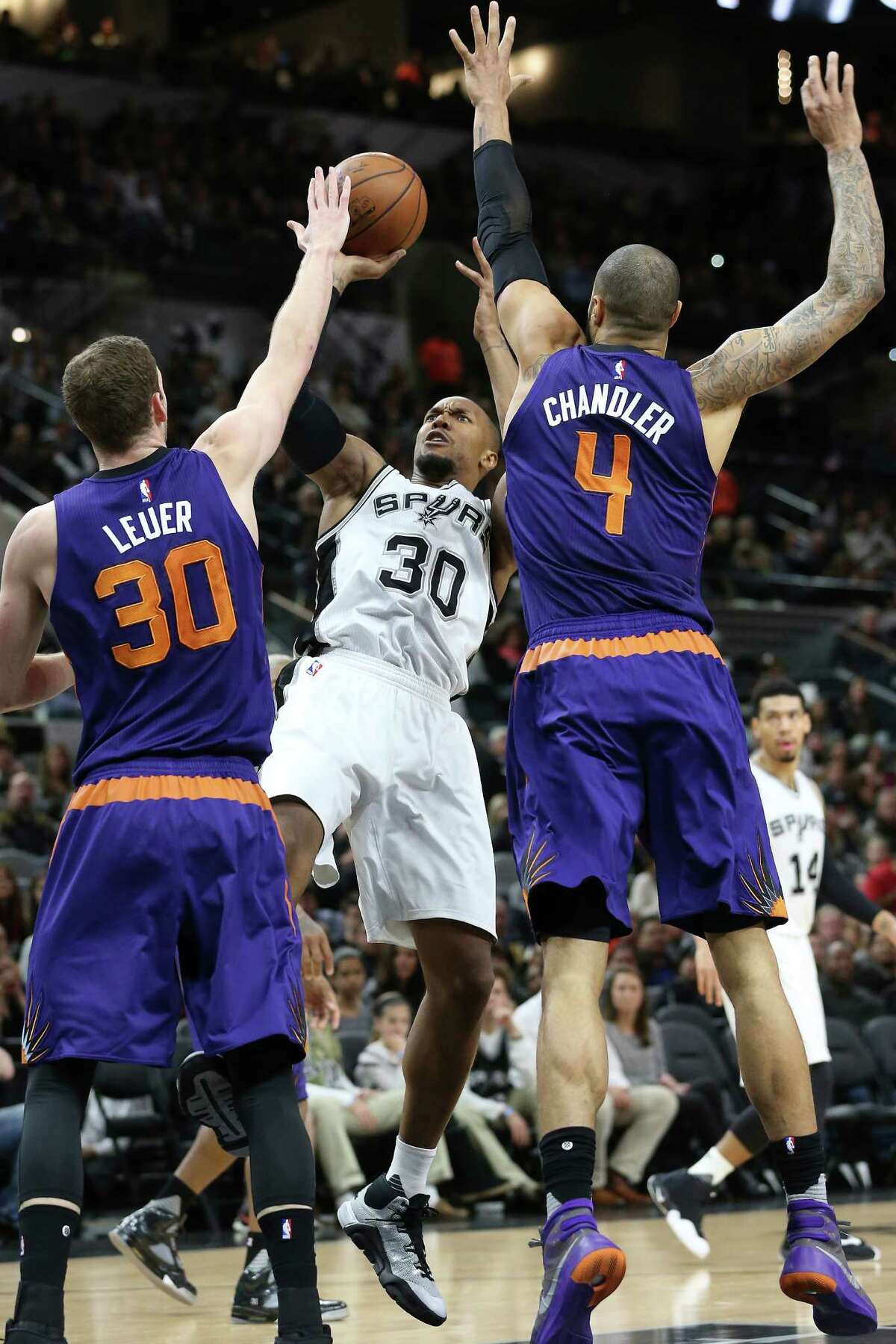 David West fades back for a shot against Jon Leuer and Tyson Chandler as the Spurs host the Suns at the AT&T Center on Dec. 30, 2015.