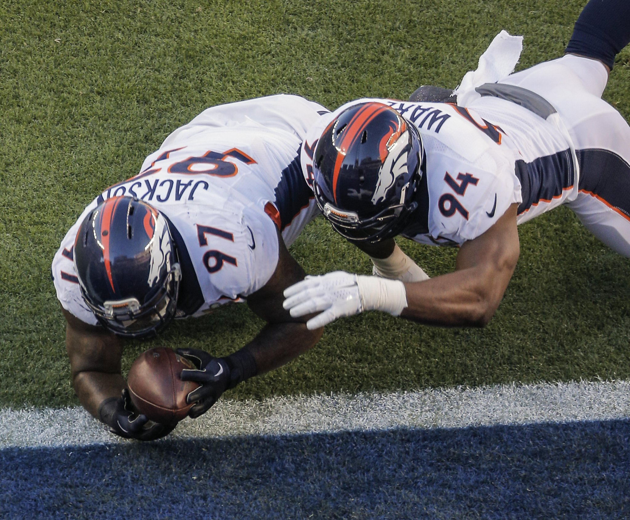 Denver Broncos Von Miller hugs head coach Gary Kubiak after giving Kubiak  the Gatorade bucket on the sidelines in the final minute of the game  against the Carolina Panthers at Super Bowl