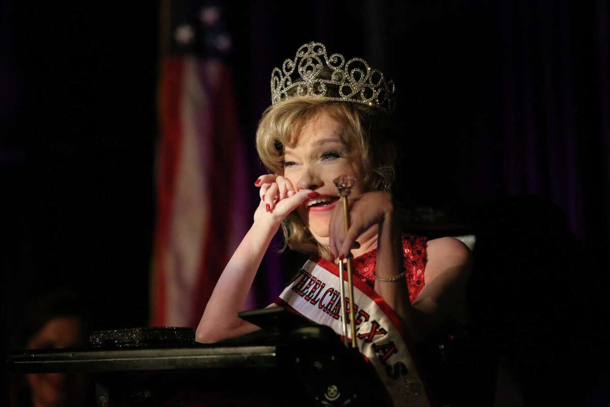 Sandy Spoonemore beams after being crowned this year's Ms. Wheelchair Texas on Saturday night at the Hyatt Regency. Spoonemore, a Baylor graduate, has spinal muscular dystrophy and has used a wheelchair since age 2.