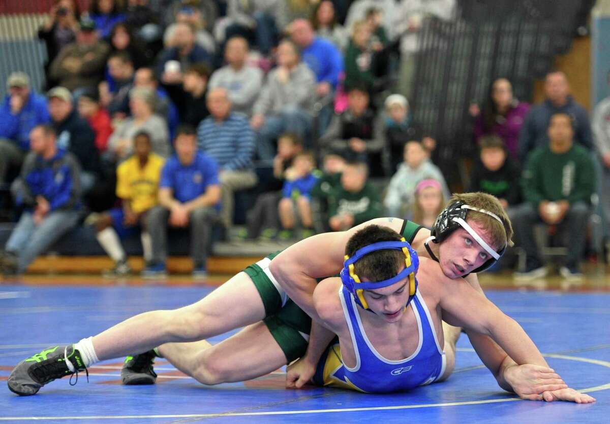 New Milford’s CJ Schultz, top, and Newtown’s Anthony Piazza wrestle in a 138-pound match at the New Fairfield Duals Saturday at New Fairfield High School.