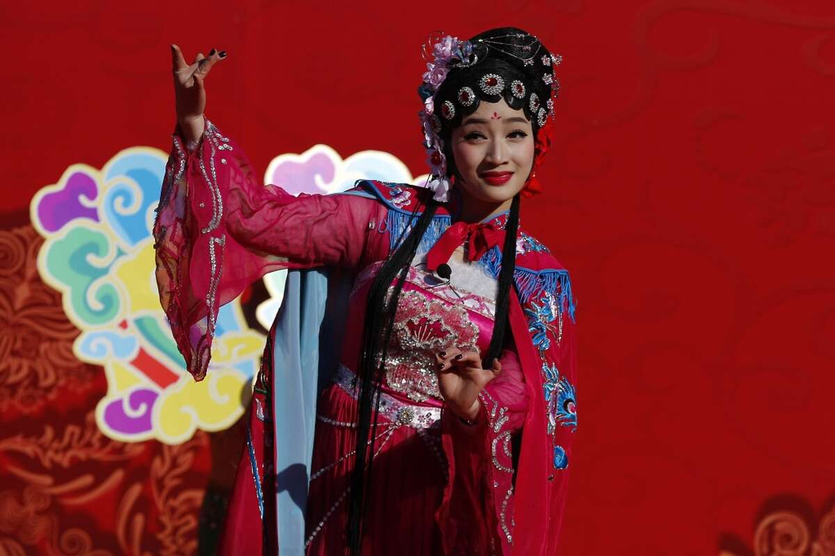 A Chinese performer dressed in traditional costume performs a cultural dance during a temple fair for a Lunar New Year celebration in Beijing, Monday, Feb. 8, 2016. Millions of Chinese began celebrating the Lunar New Year, which marks the Year of the Monkey on the Chinese zodiac. (AP Photo/Andy Wong)