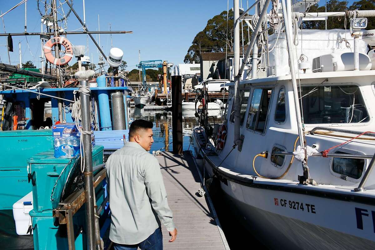 Vincent Pham walks to his boat in the harbor in Santa Cruz, Calif. on Monday, February 8, 2016. The Small Business Administration is offering small disaster loans to businesses affected by the delayed dungeness crab season.