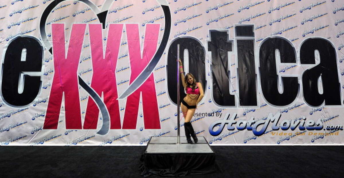 A pole dancer performs on opening day of the 2011 Exxxotica Expo on August ...