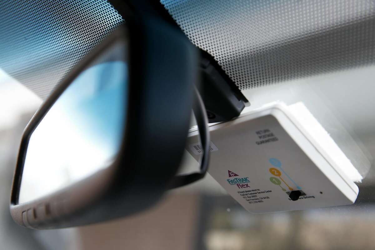 A FasTrak Flex transponder, equipped with a switch to set for the number of occupants for use on new Interstate 580 express lanes, is attached to a windshield in Pleasanton, Calif. on Tuesday, Feb. 9, 2016. The new lanes which may cost up to $13 for solo drivers to travel for the entire 14-mile corridor, is scheduled to open before the end of the month.