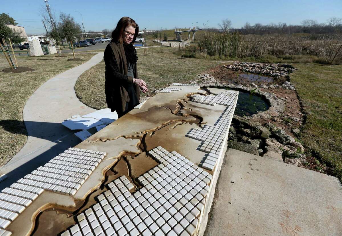 Anne Olson, president of the Buffalo Bayou Partnership, shows how bayou water will flow from a solar-powered cistern into wetlands at Buffalo Bend Nature Park.﻿