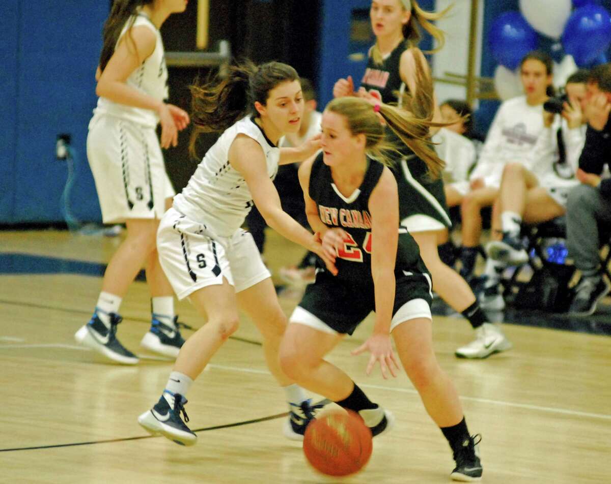New Canaan's Kylie Murphy, right, looks to dribble past Staples' Gabby Perry during a girls basketball game on Tuesday, February 9th, 2016.
