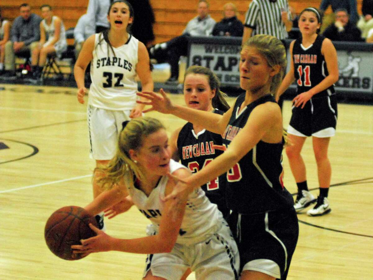 New Canaan's Campbell Armstrong, right, defends Staples' Ellie Fair during a girls basketball game on Tuesday, February 9th, 2016.