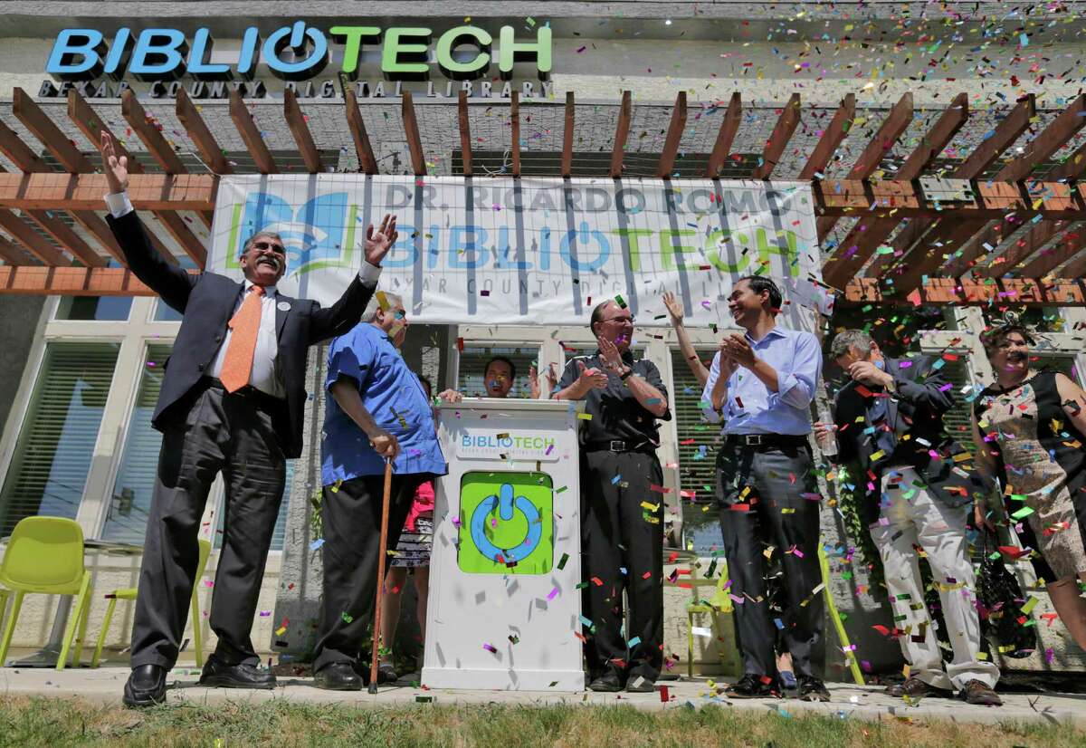 UTSA President Ricardo Romo (from left), Bexar County Commissioner Paul Elizondo, Bexar County Judge Nelson Wolff, HUD Secretary Julian Castro and other dignitaries celebrate the opening of the second Bibliotech named after Romo at the Gardens of San Juan Square - a San Antonio Housing Authority Community - on Saturday, July 25, 2015. The nation's first all-digital public library, Bibliotech added a second branch in the public housing development located on the city's westside. Romo grew up on the Westside and was honored by having his name emblazoned on the library. Bibliotech gives Bexar County residents access to 38,000 titles which can be accessed via all digital devices and computers. Book titles can also be checked out on e-readers for a two-week period. Gardens of San Juan Square is SAHA's newest mixed-income community that has 539 units. There are currently more than 65,000 registered users of the digital library and over 181,000 on-site visitors to the first location on Pleasanton Road. (Kin Man Hui/San Antonio Express-News)