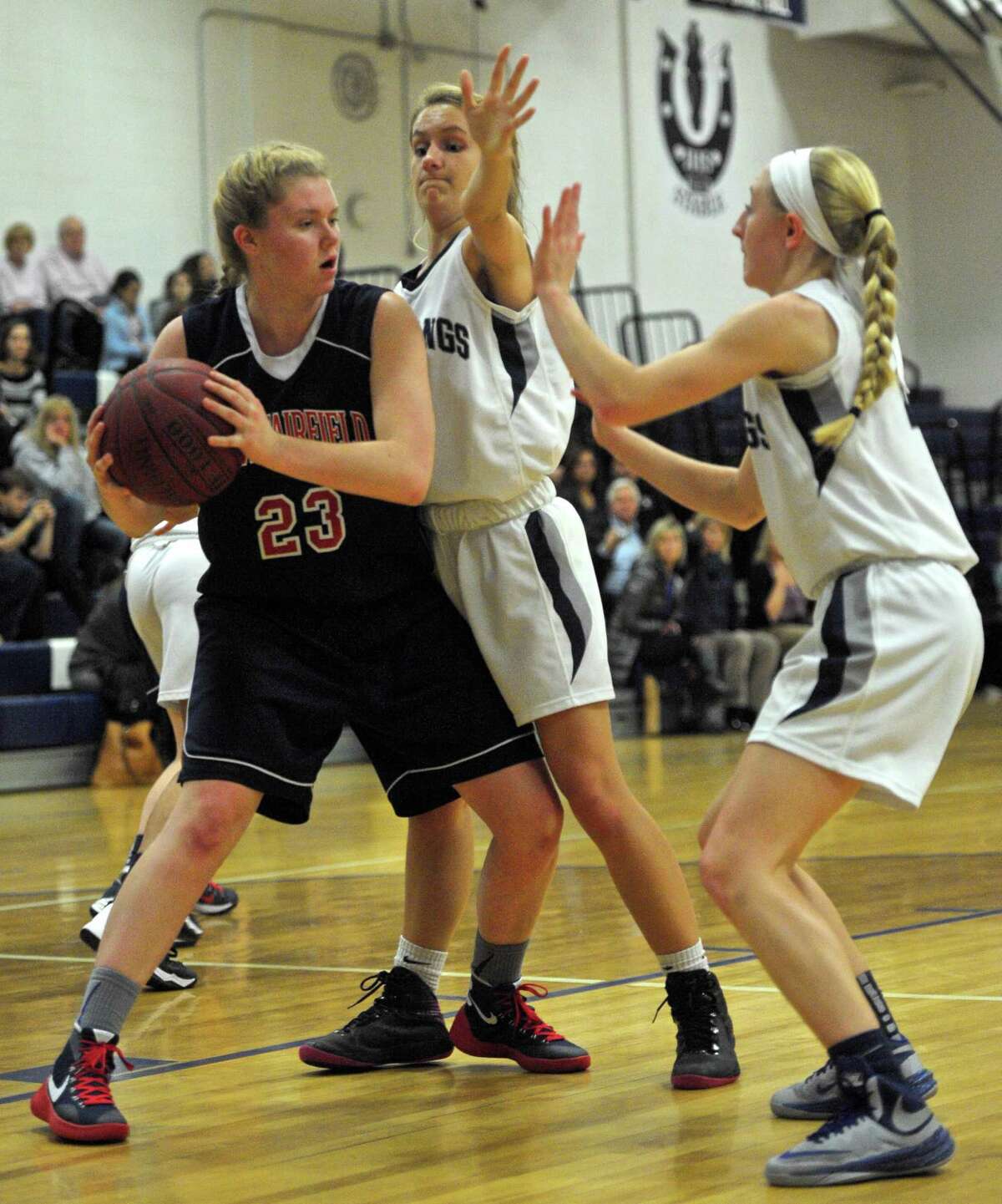FILE PHOTO: Immaculate's Marcella Daily (12) and Caroline Wax (4) box in New Fairfield's Kristen Teklits (23) after she pulled down a rebound in the girls basketball game between New Fairfield and Immaculate high school, on Tuesday night, February 2, 2016, at Immaculate High School, in Danbury, Conn.