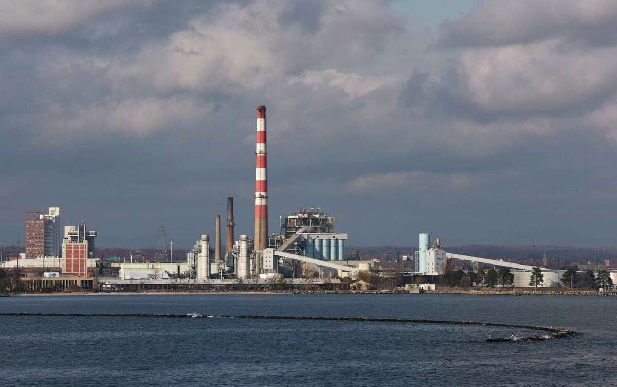 The red and white smokestack from the PSEG Power Connecticut coal-burning power plant, the last of its kind in New England, stretches high into the skyline of Bridgeport Harbor in Bridgeport, Conn. Wednesday, Nov. 12, 2014.