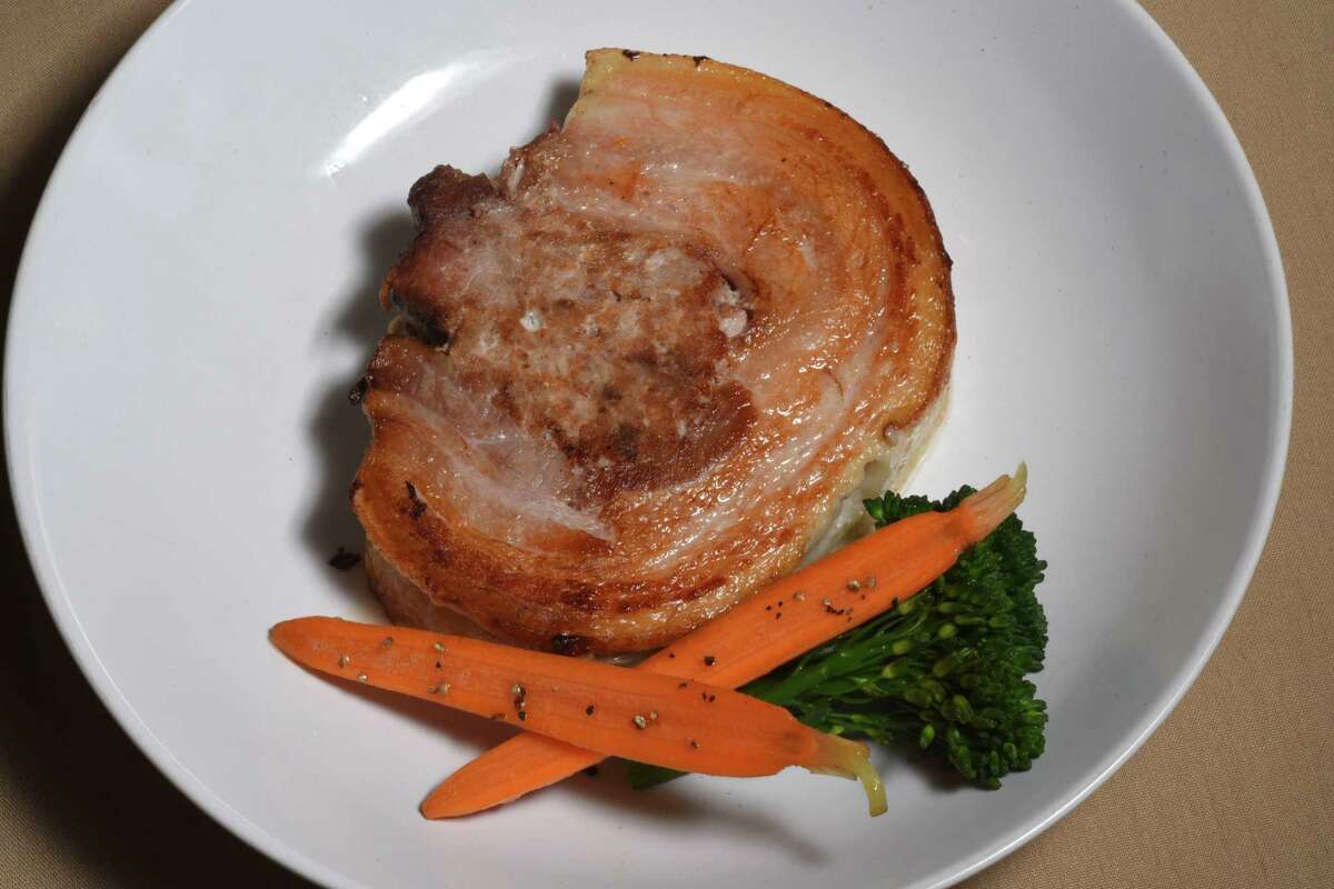 Porchetta, a stuffed pork belly with house-made sausage and marinated shoulder