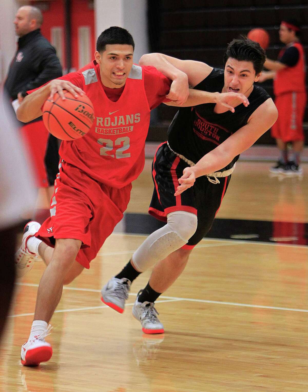 Nick Hernandez (left) drives during practice with the South Houston High School boys basketball team, Thursday, Feb. 11, 2016, in Houston. Hernandez, a senior, has been a critical part of the Trojans' success. They have won 21 of their last 22 games, and they will play Friday night for the District 22-6A championship.