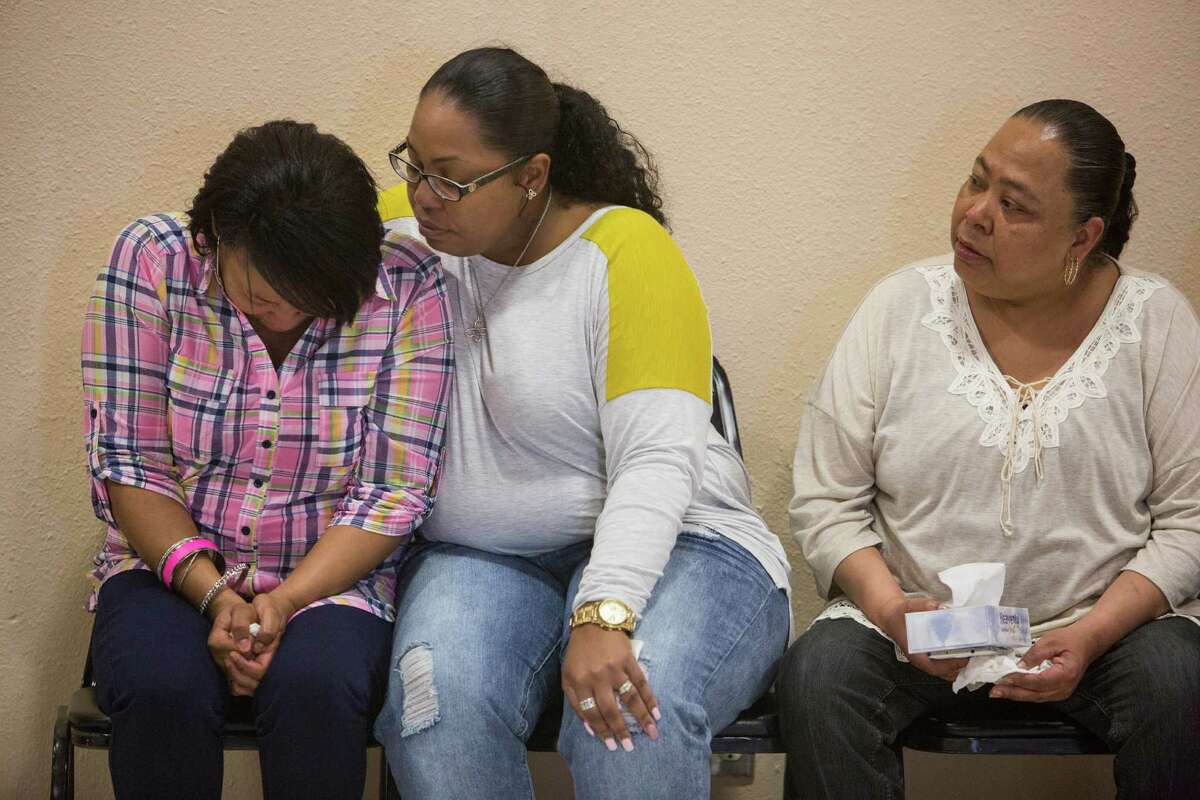 Charissa Sprawling-Mickles, center, comforts her sister Elena Sprawling-Scott during a press conference held at the Barbara Jordan Community Center about Antronie Scott's death in San Antonio, Texas on February 6, 2016. Scott, who was unarmed, was shot and killed by a San Antonio police officer outside of his car on Thursday evening as his wife Elena Sprawling-Scott watched from the passenger seat.
