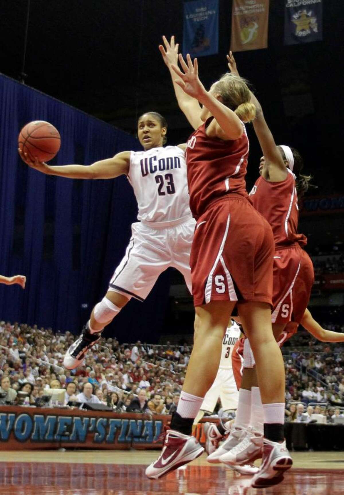 Connecticut's Maya Moore (23) attempts a shot over Stanford's Jayne Appel, front, in the first half of the women's NCAA Final Four college basketball championship game Tuesday, April 6, 2010, in San Antonio. (AP Photo/Eric Gay)