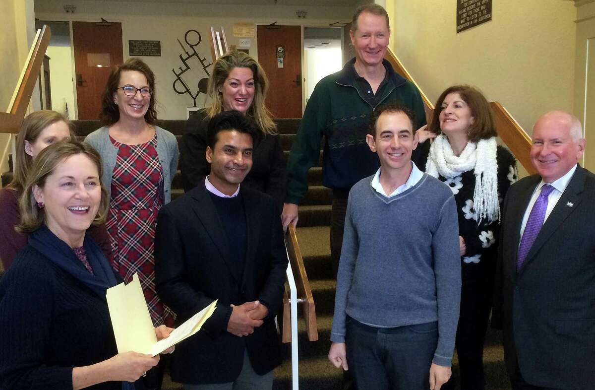 Officials gather at Town Hall to welcome Vik Muktavaram, center, as a new member of the Board of Education after his swearing-in. They are, from left, Town Clerk Patricia Strauss, Representative Town Meeting Moderator Eileen Flug, Board of Education member Karen Kleine, Muktavaram, Board of Education Vice Chairwoman Jeannie Smith, Board of Education member Mark Mathias, Board of Education Chairman Michael Gordon, Board of Education member Brett Aronow and First Selectman Jim Marpe.