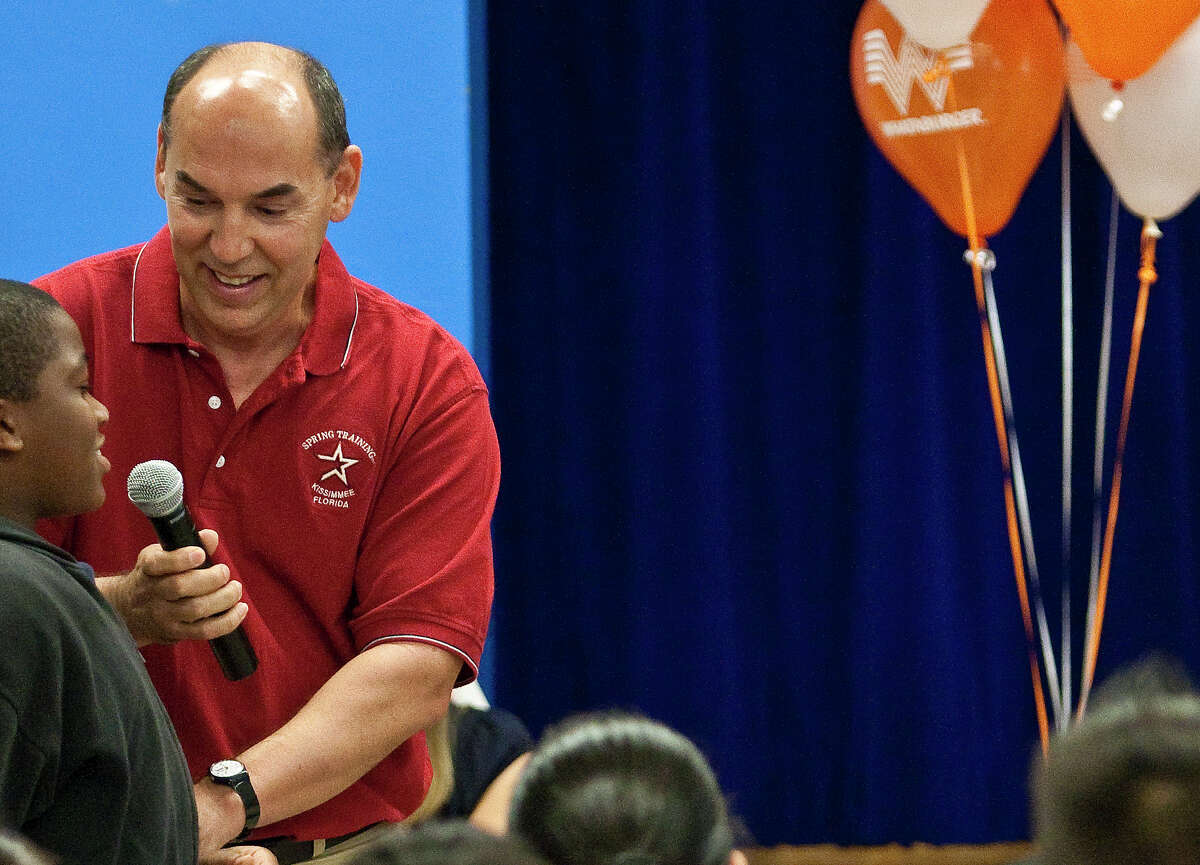 Houston Astros' Spanish-language radio announcer Alex Trevino helps fifth-grader Ryan Davis ask a question, during a Fielder's Choice Program event, Friday, May 8, 2009, at Looscan Elementary School in Houston, Texas.