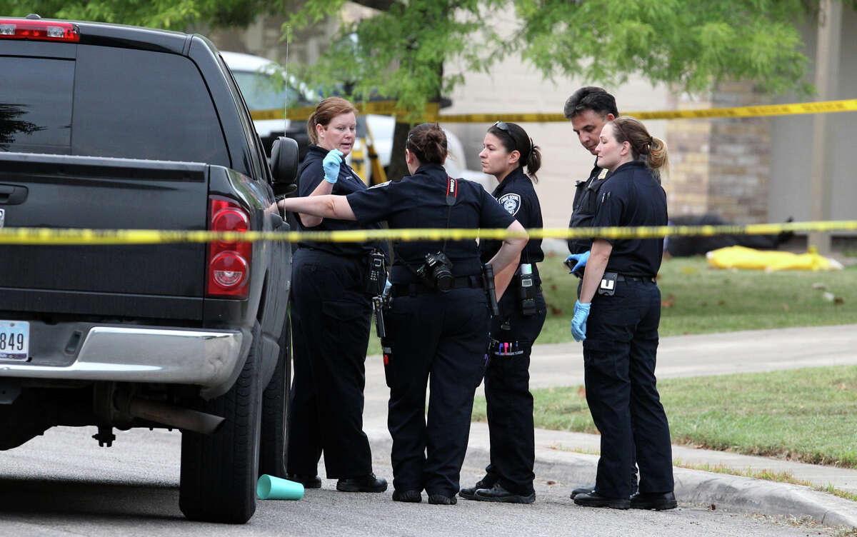 San Antonio police and investigators work at the scene of a fatal shooting that took place around 3:00 a.m. Friday July 27, 2012 on the 2000 block of Field Wood on the city's West Side. An under cover police officer shot the man who was the ex-boyfriend of a woman who called the officer asking for help. The woman was shot in the torso and wrist and the police officer was not injured. The incident is still being investigated. John Davenport/Â¨San Antonio Express-News