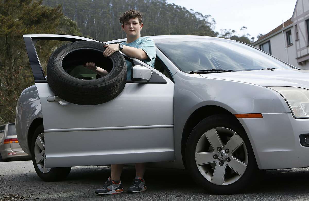 Elementary school teacher Liz Gustin was recently hit by a piece of concrete from the Yerba Buena tunnel which fell near the passenger side of her car while trying to avoid it in San Francisco, California. She shows a popped back tire and damages to the passenger side on Friday, February 12, 2016.