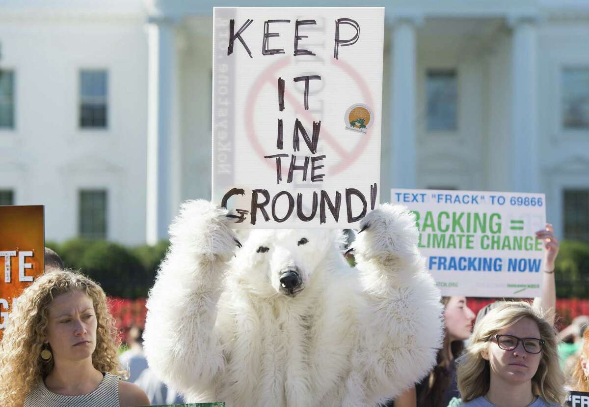 Environmental activists, including one wearing a polar bear costume, protest the Obama administration's plans to allow new fossil fuel drilling on public lands and oceans, during a demonstration held by the "Keep it in the Ground" coalition in front of the White House in Washington, DC, September 15, 2015. AFP PHOTO / SAUL LOEB (Photo credit should read SAUL LOEB/AFP/Getty Images)