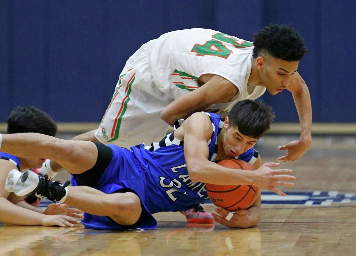 Lanier's Israel Serna dives for a loose ball in front of Sam Houston's Robert Christian.