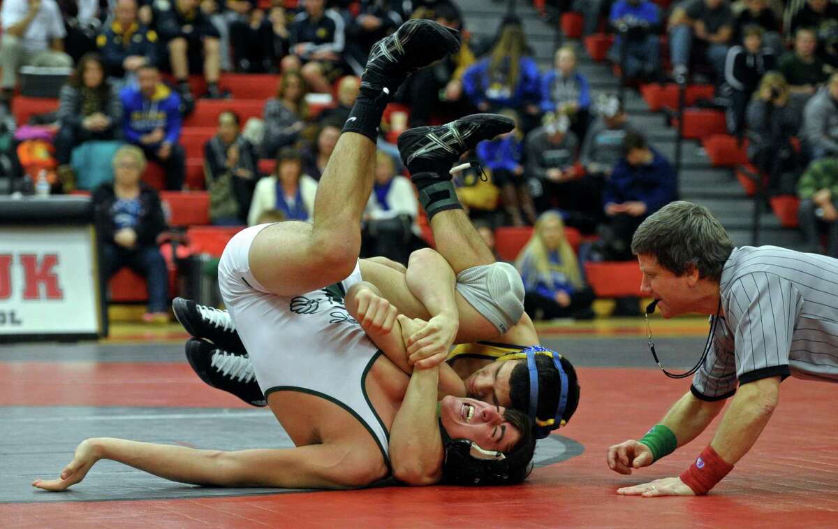 Newtown’s Joe Accousti and New Milford's Kyle Fabich wrestle in the 170 pound weight class championship match during the SWC wrestling championships, held at Masuk High School on Saturday. Accoousti won the match.