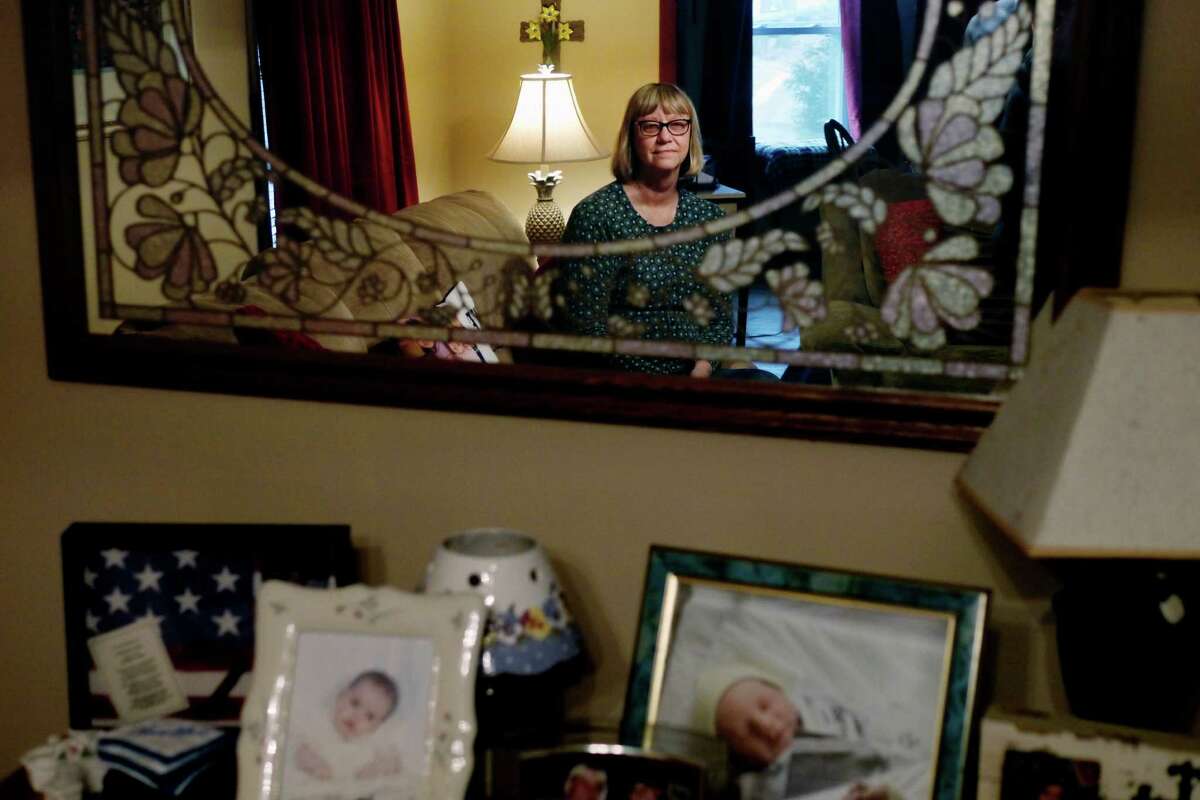 Nancy Rivera is reflected in a mirror as she poses for a photo at her home on Monday, Feb. 8, 2016, in Troy, N.Y. Rivera suffers from medical issues that would allow her access to medical marijuana, but so far hasn't gotten any assistance from her doctor to get it. (Paul Buckowski / Times Union)