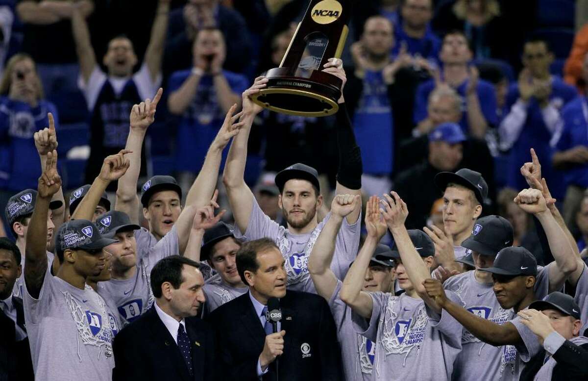 Duke players celebrate with the championship trophy after their 61-59 win over Butler in the men's NCAA Final Four college basketball championship game Monday, April 5, 2010, in Indianapolis.